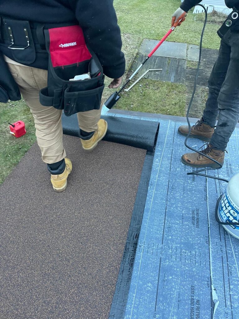 Bitumen roof installation in progress